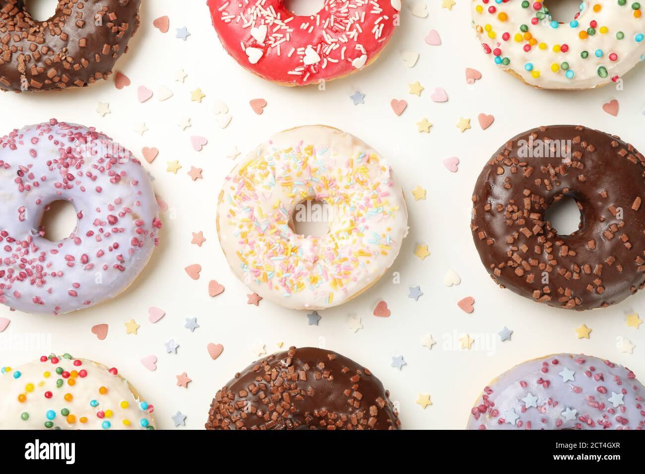 Flat lay with tasty donuts on white background Stock Photo