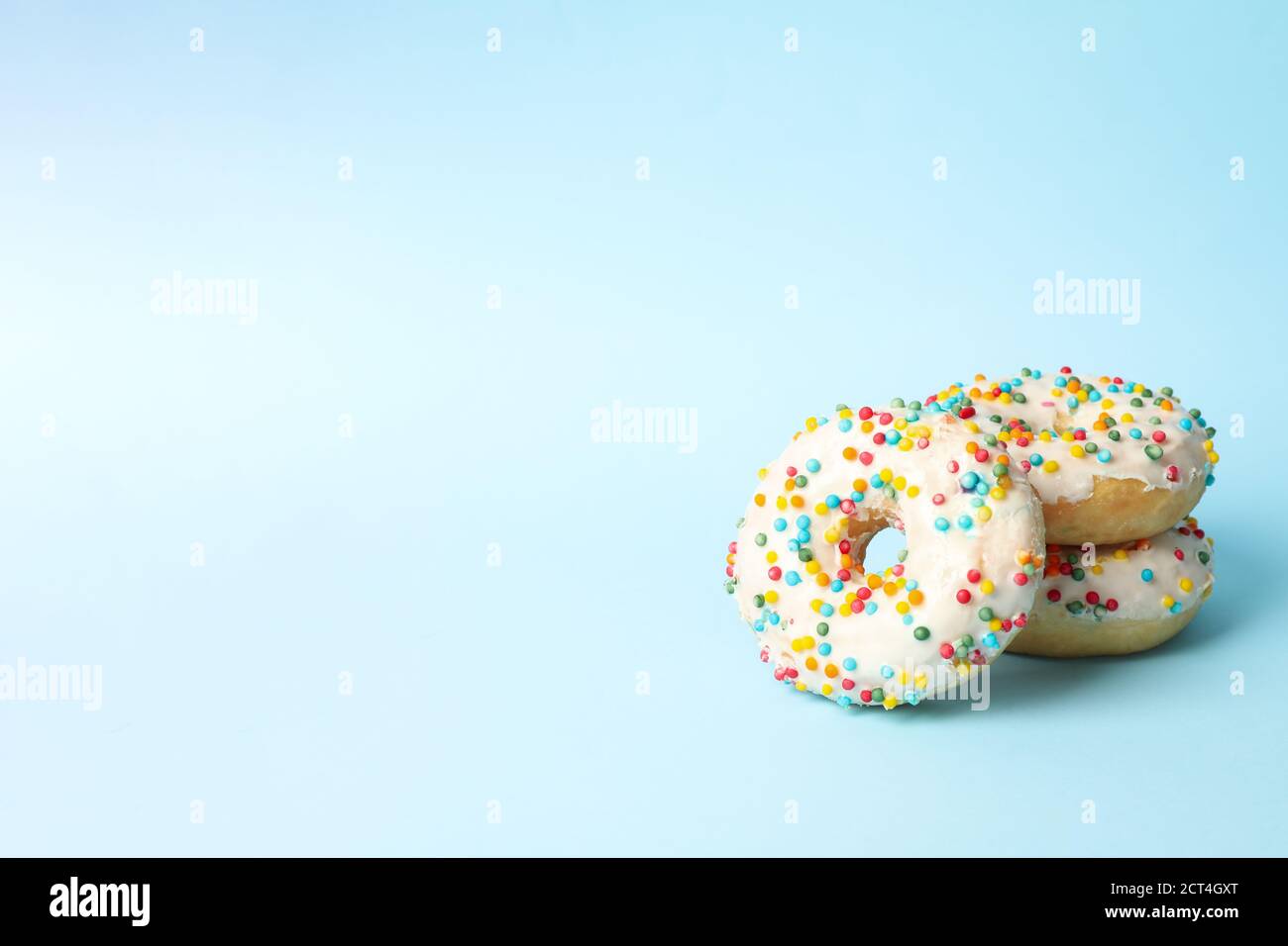 Tasty donuts on two tone background, space for text Stock Photo