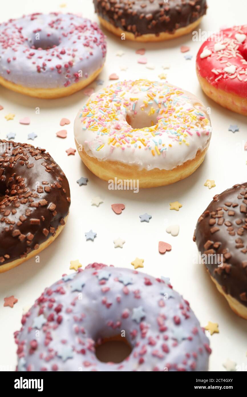 Flat lay with tasty donuts on white background Stock Photo
