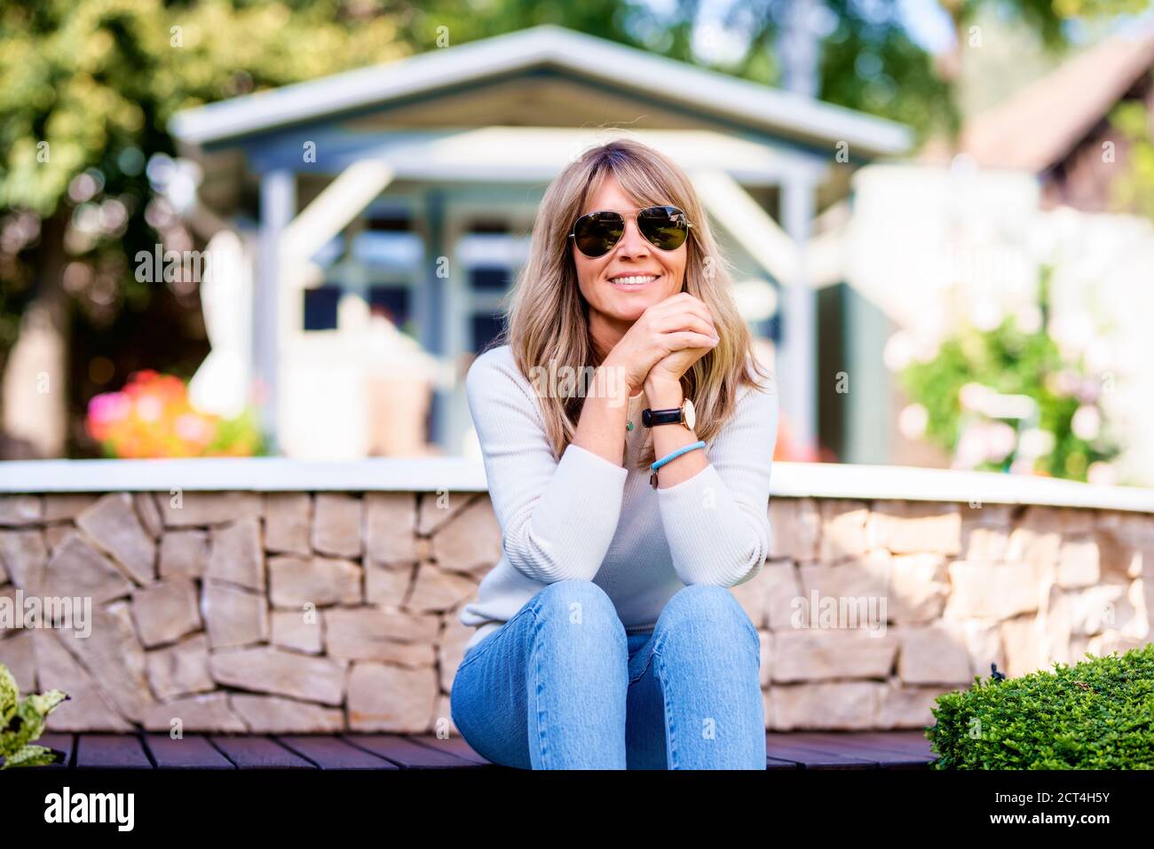 Mature woman relaxing in garden hi-res stock photography and images - Alamy