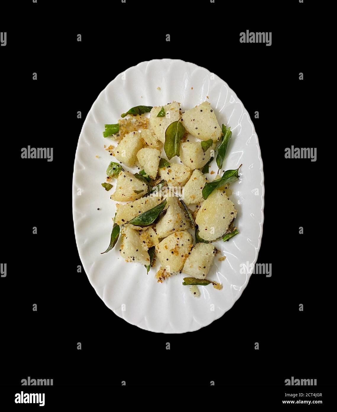 Delicious Seasoned or Fry Idly or idli served in a plate Stock Photo