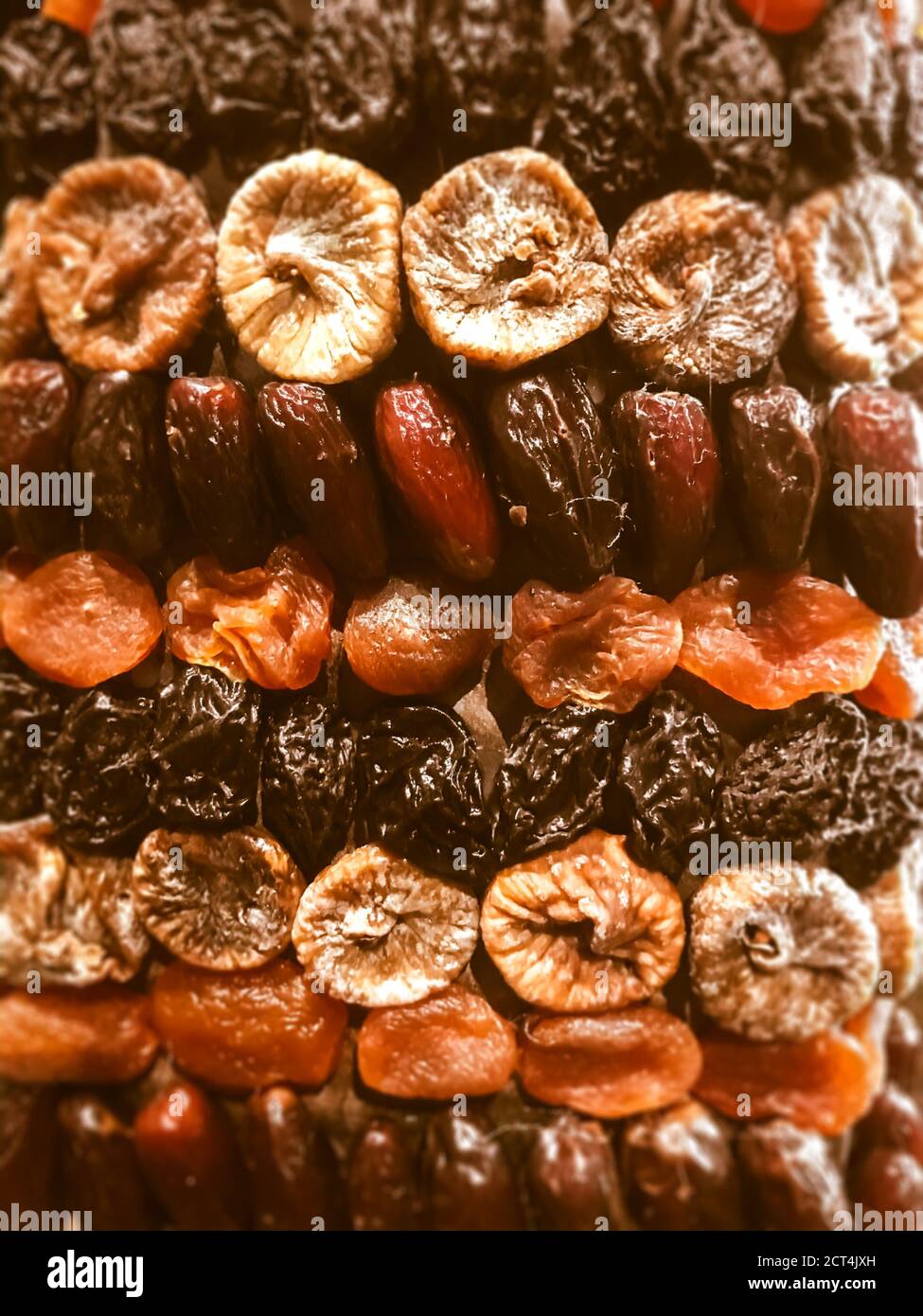 Organic dried fruits background made of figs, dates, prunes and