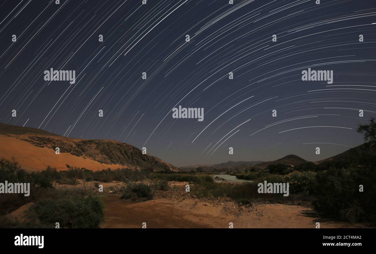 A landscape image of the Kunene River separating Namibia and Angola at night. Stock Photo
