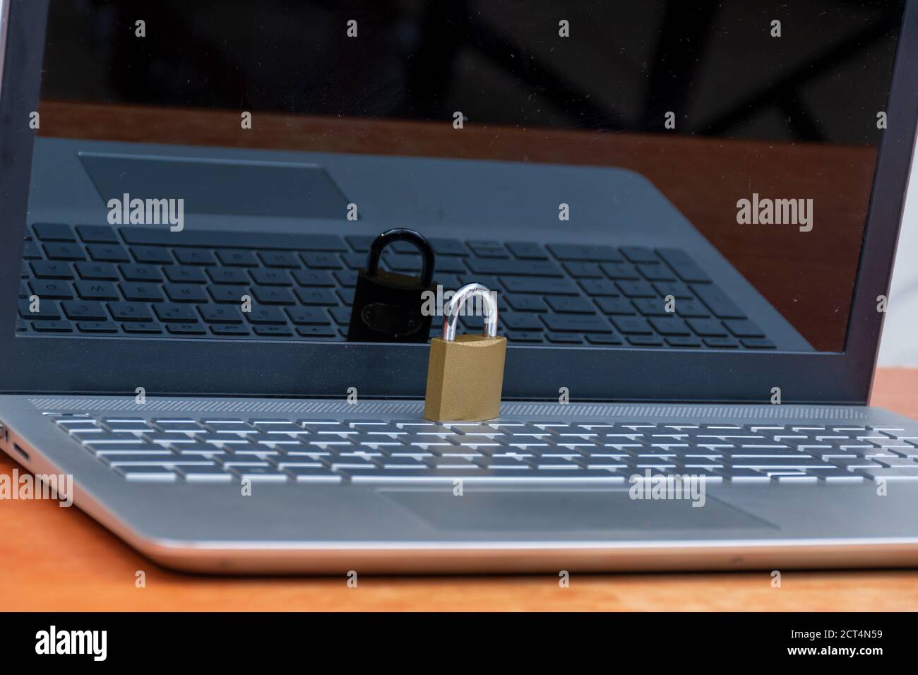 a secure laptop concept, locked padlock placed on a laptop computer Stock Photo