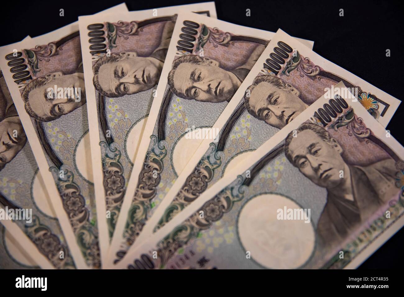 Japanese currency 100,000 yen on the black background closeup Stock