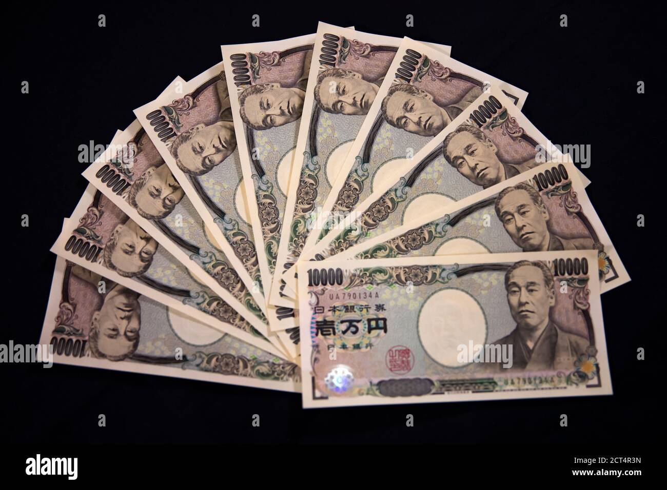 Japanese currency 100,000 yen on the black background closeup Stock Photo -  Alamy