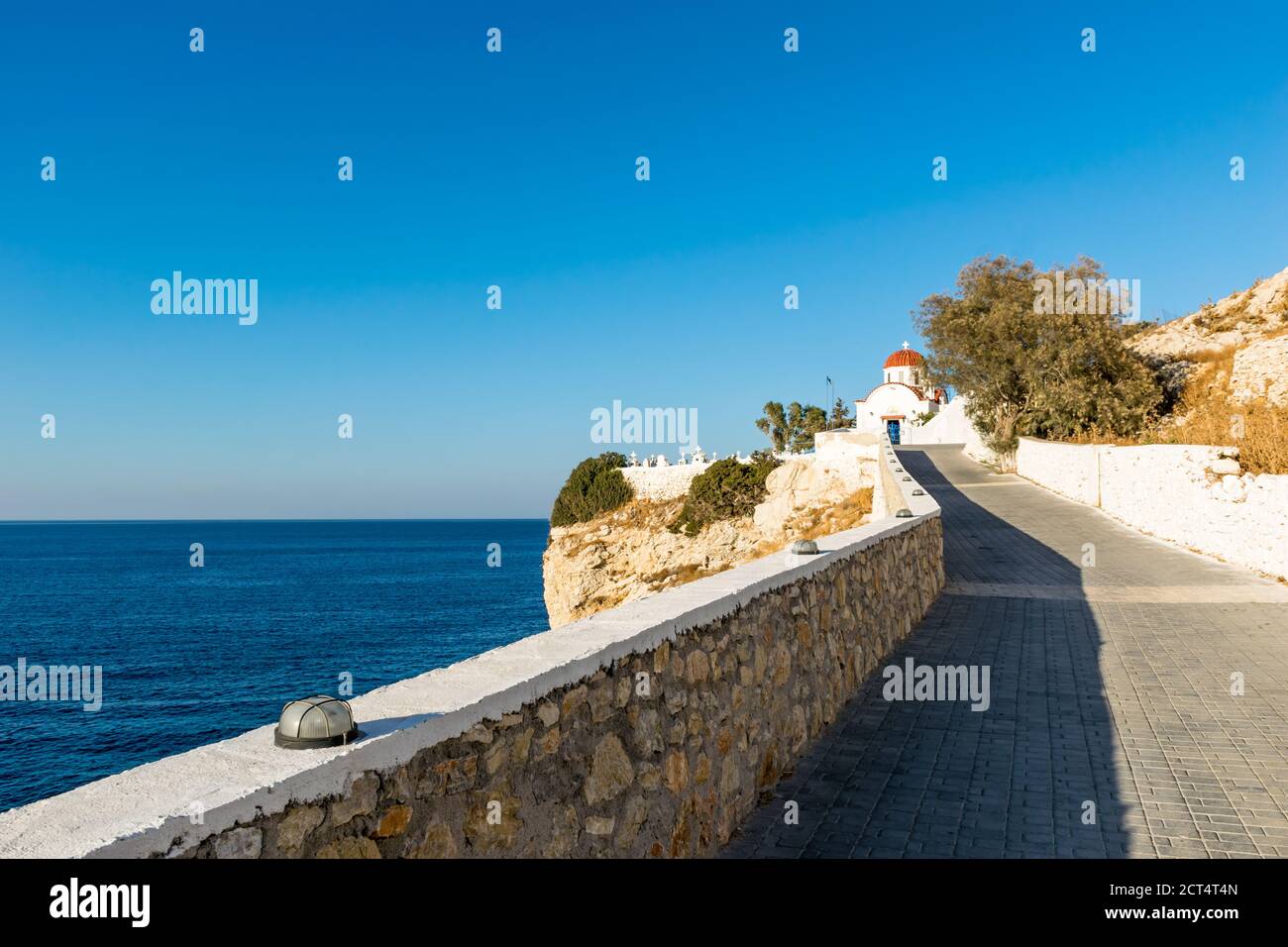 Path leading to Church and Cemetery above the sea in Pigadia, Karpathos, Greece Stock Photo
