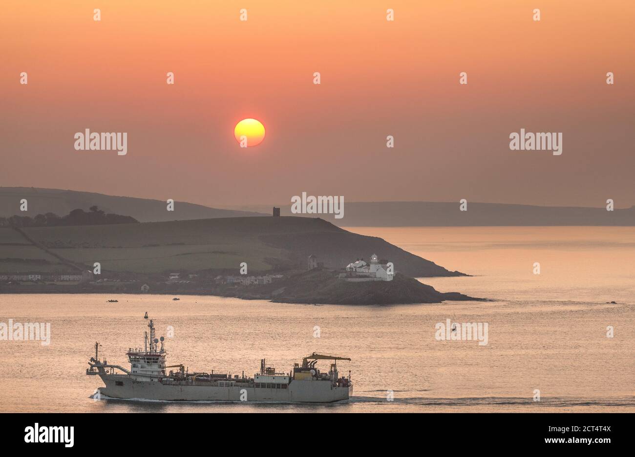 Roches Point, Cork, Ireland. 21st September, 2020. Dredger, Taccola enters Cork Harbour as the sun starts to rise at Roches Point, Cork, Ireland. - Credit; David Creedon / Alamy Live News Stock Photo