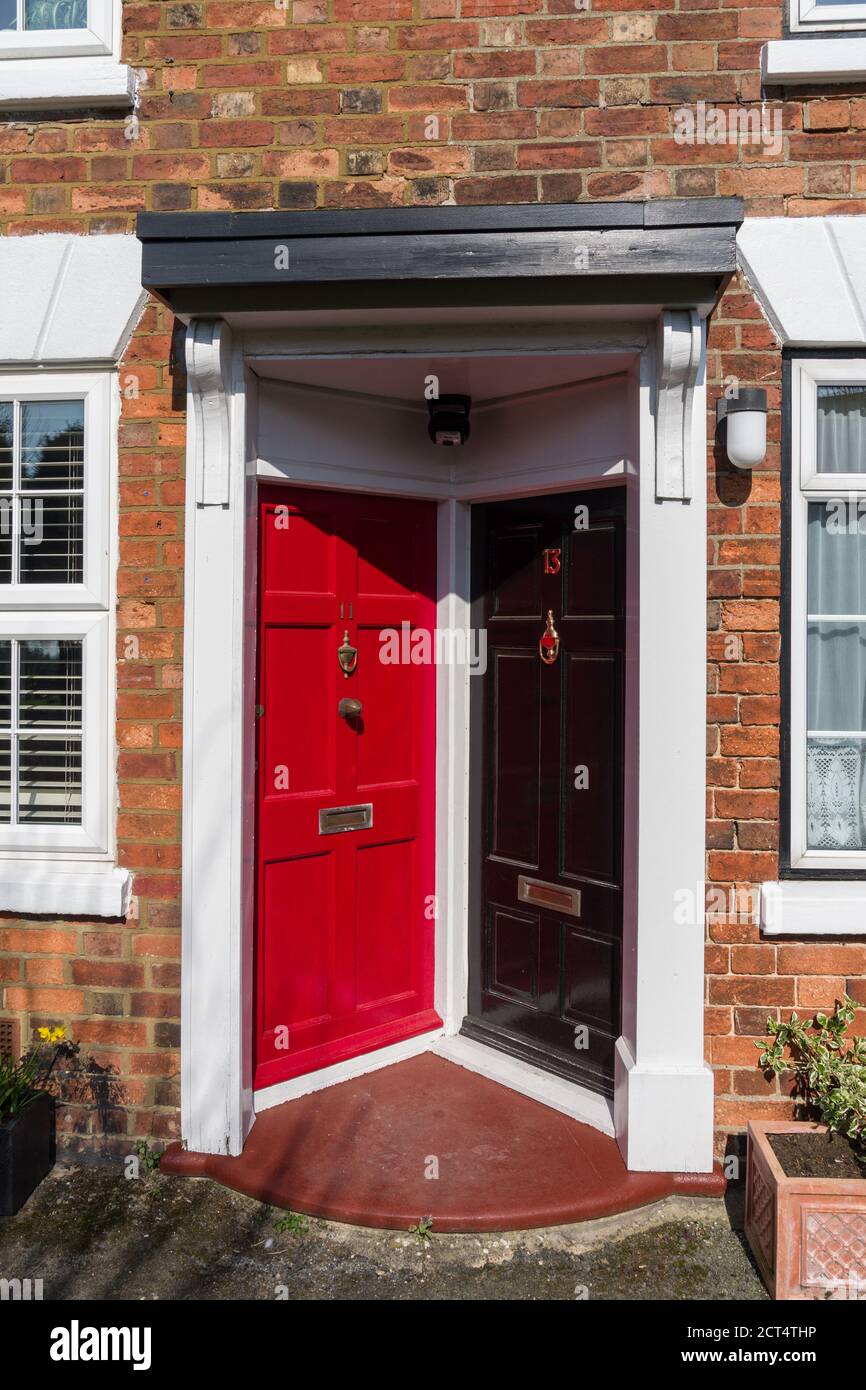 Adjoining front doors at right angles to each other in a terrace of houses, Hanslope, Buckinghamshire, UK Stock Photo