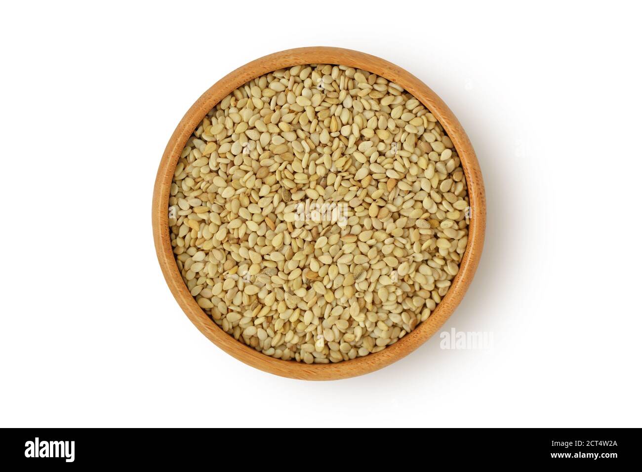 Sesame seeds in wooden bowl on white background Stock Photo