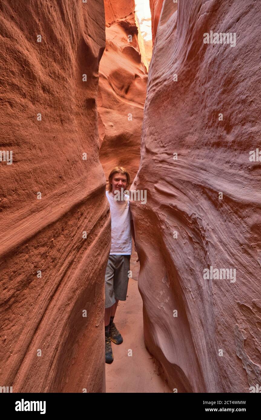 Hiker at Spooky Gulch, a slot canyon, Early Weed Bench area, BLM Land, formerly part of Grand Staircase Escalante National Monument, Utah, USA Stock Photo
