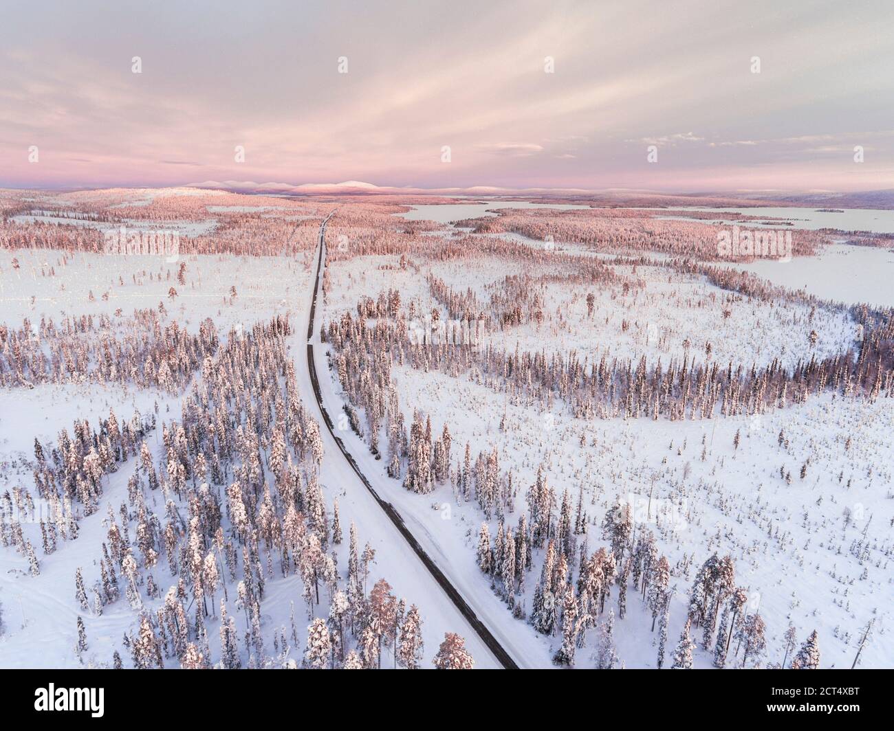 Dangerous, icy winter roads in bad, slippery, ice and snow covered driving conditions in amazing beautiful road trip scenery and landscape Stock Photo