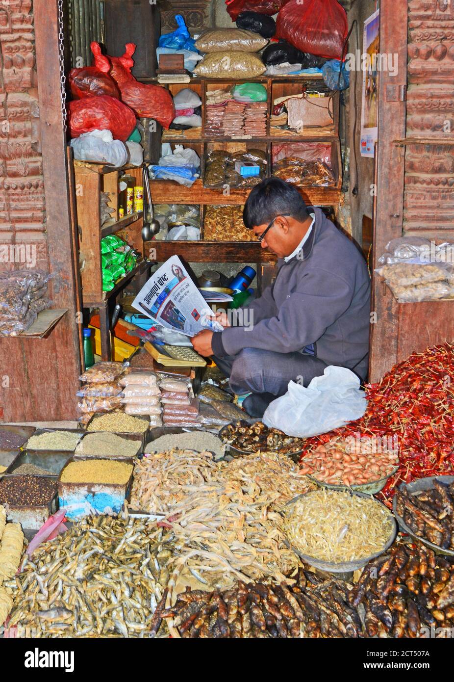 shopkeeper reading the newspaper in his shop, Kathmandu, Nepal Stock Photo
