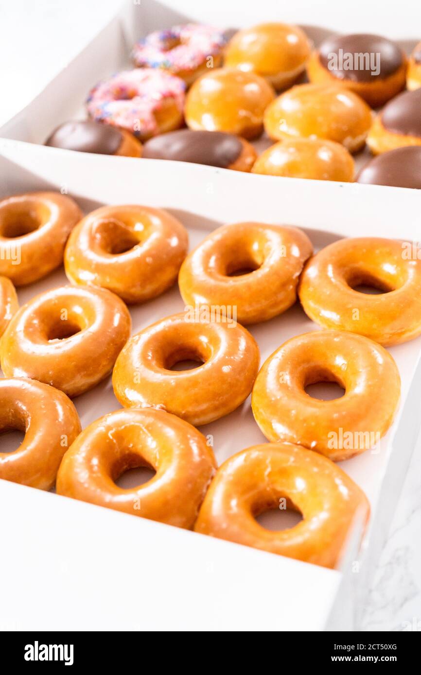 Variety of storebought doughnuts in a white paper box Stock Photo Alamy