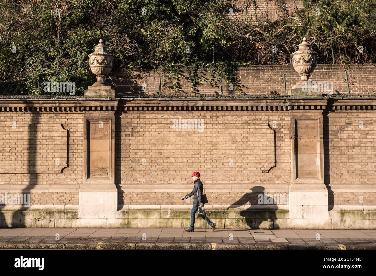 Walking past the walls of Buckingham Palace, London, England Stock