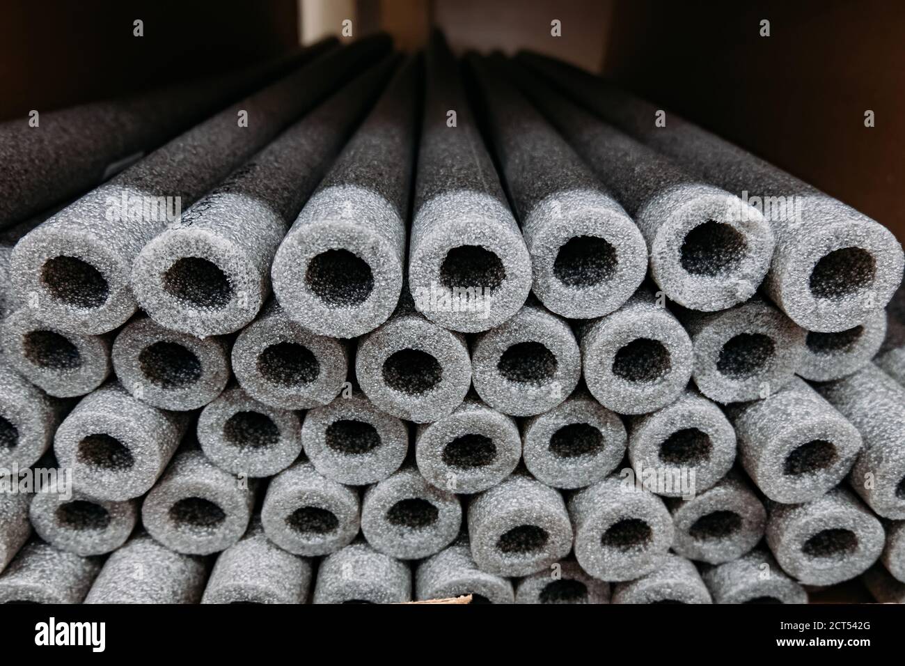 Stacked insulation for pipes of polyethylene foam in warehouse Stock
