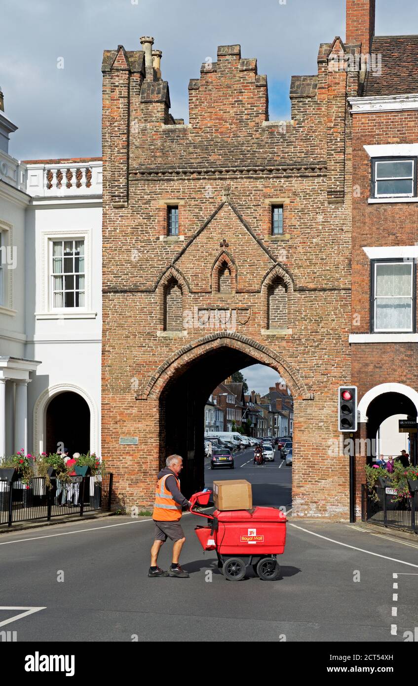 Postman with trolley, delivering the mail, North Bar in Beverley, East Yorkshire, England UK Stock Photo