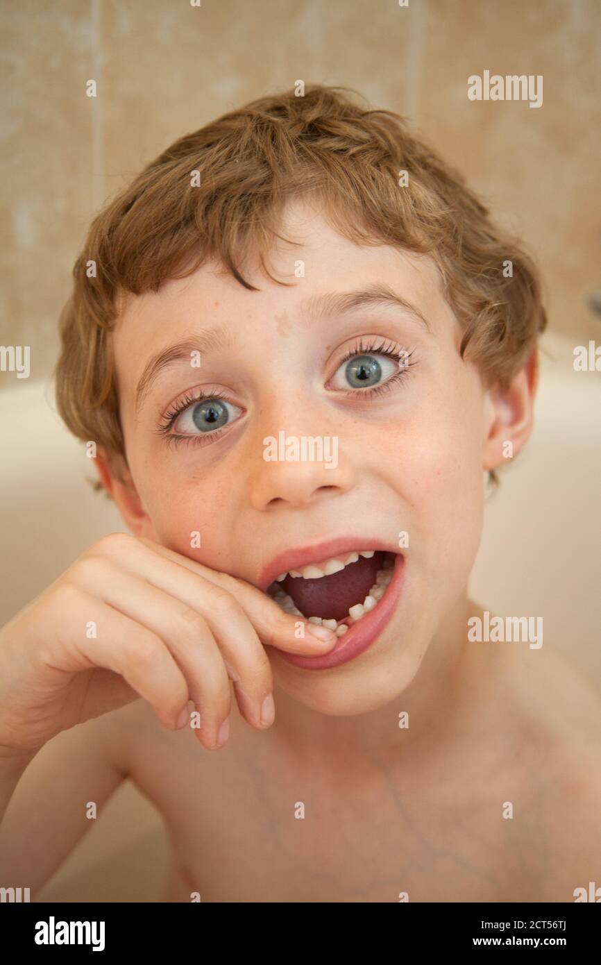 Five year old boy with a wobbly front tooth, Hampshire, England, United Kingdom. Stock Photo