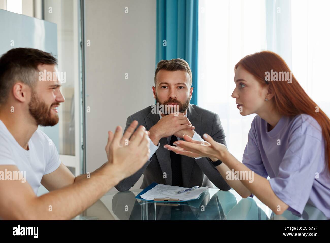 even professional psychologist is powerless to solve family problems, young caucasian couple is arguing in the presence of psychologist, listening the Stock Photo