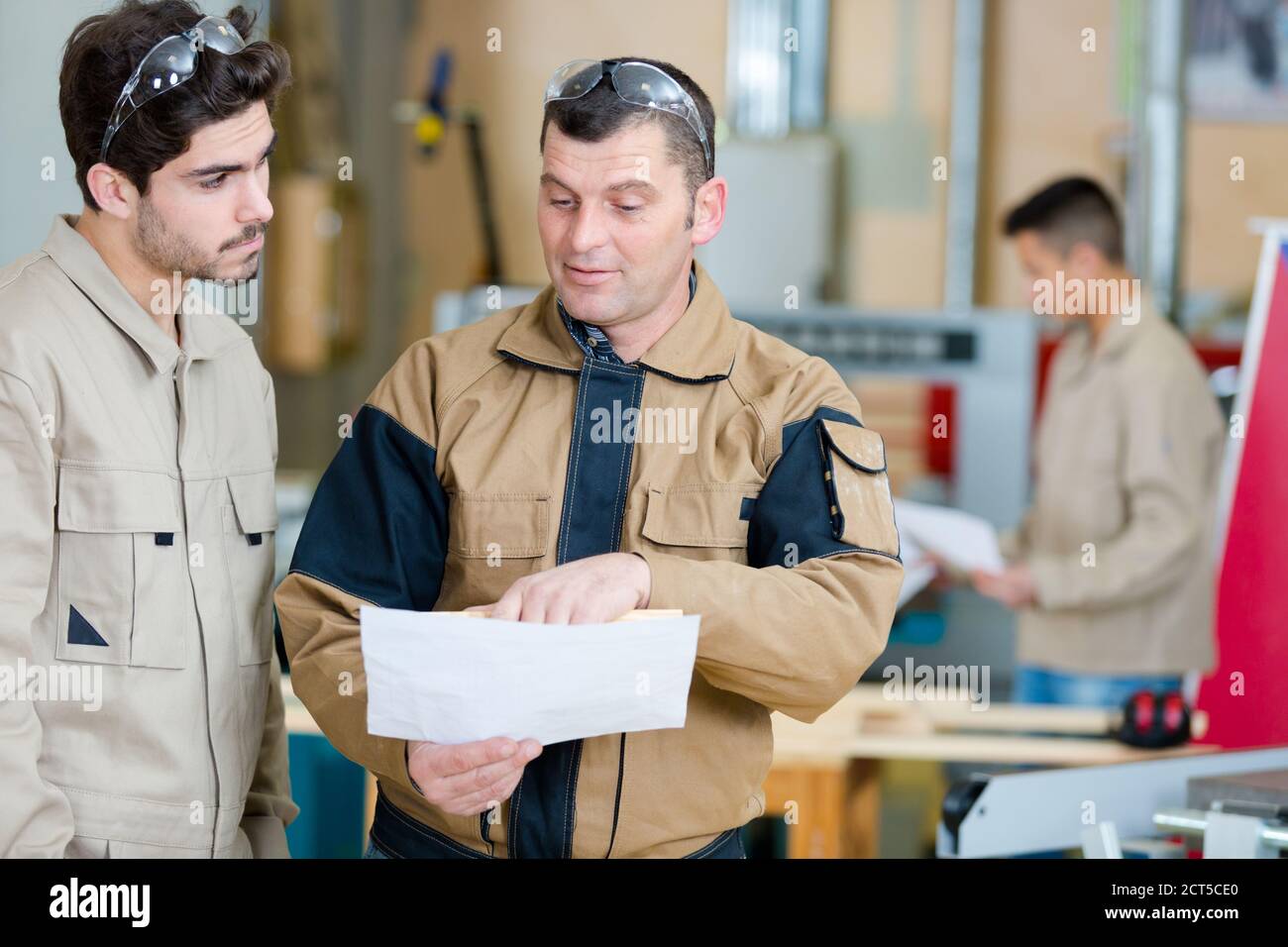 happy male worker showing something to coworker Stock Photo