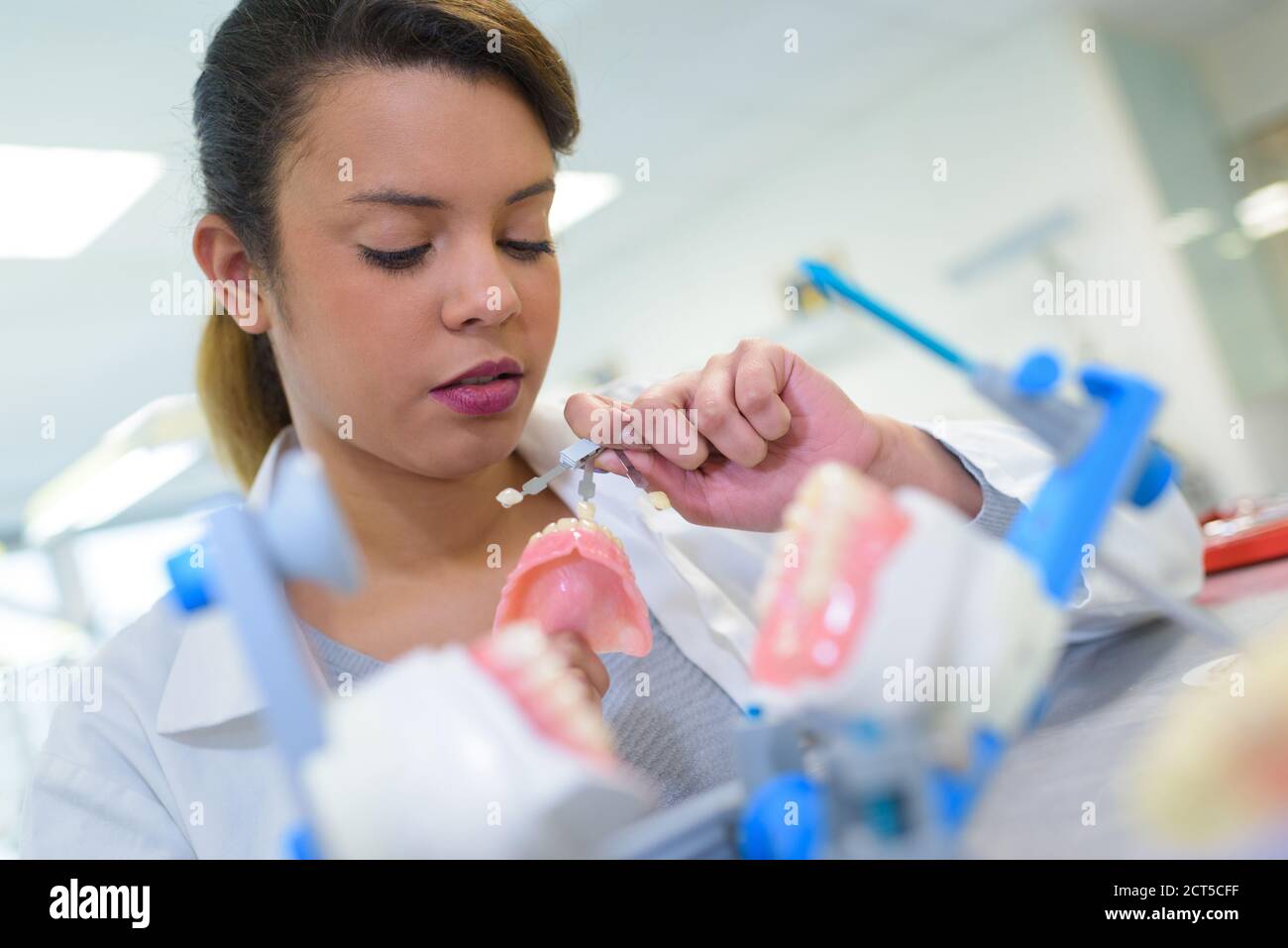 technician polishing or grinding a dental implant Stock Photo Alamy