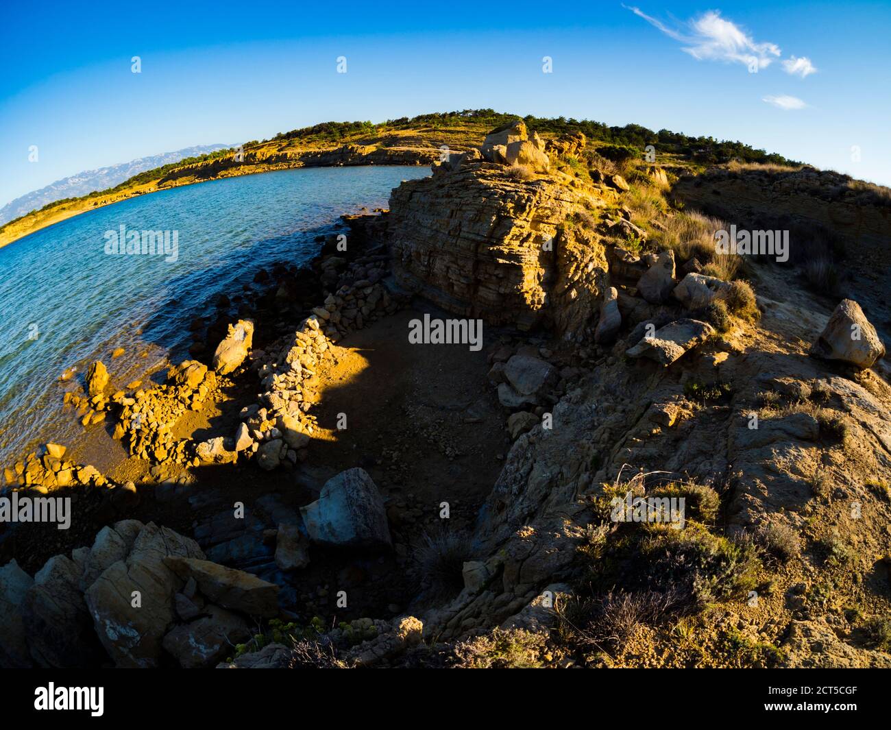 Very late afternoon sunset sidelight in Lopar on Rab island in Croatia Europe fisheye ultrawide view of unusual natural rough structure terrain marl Stock Photo