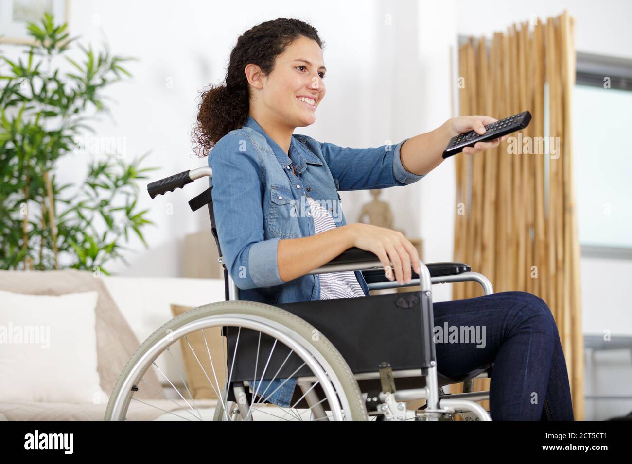 disabled woman in wheelchair watching movies at home Stock Photo Alamy