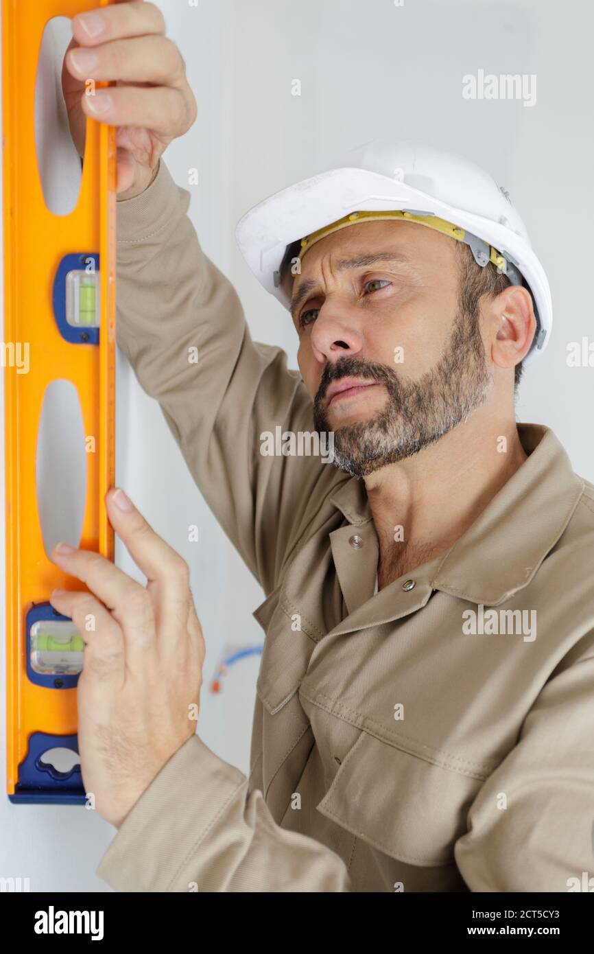 worker using laser line level Stock Photo