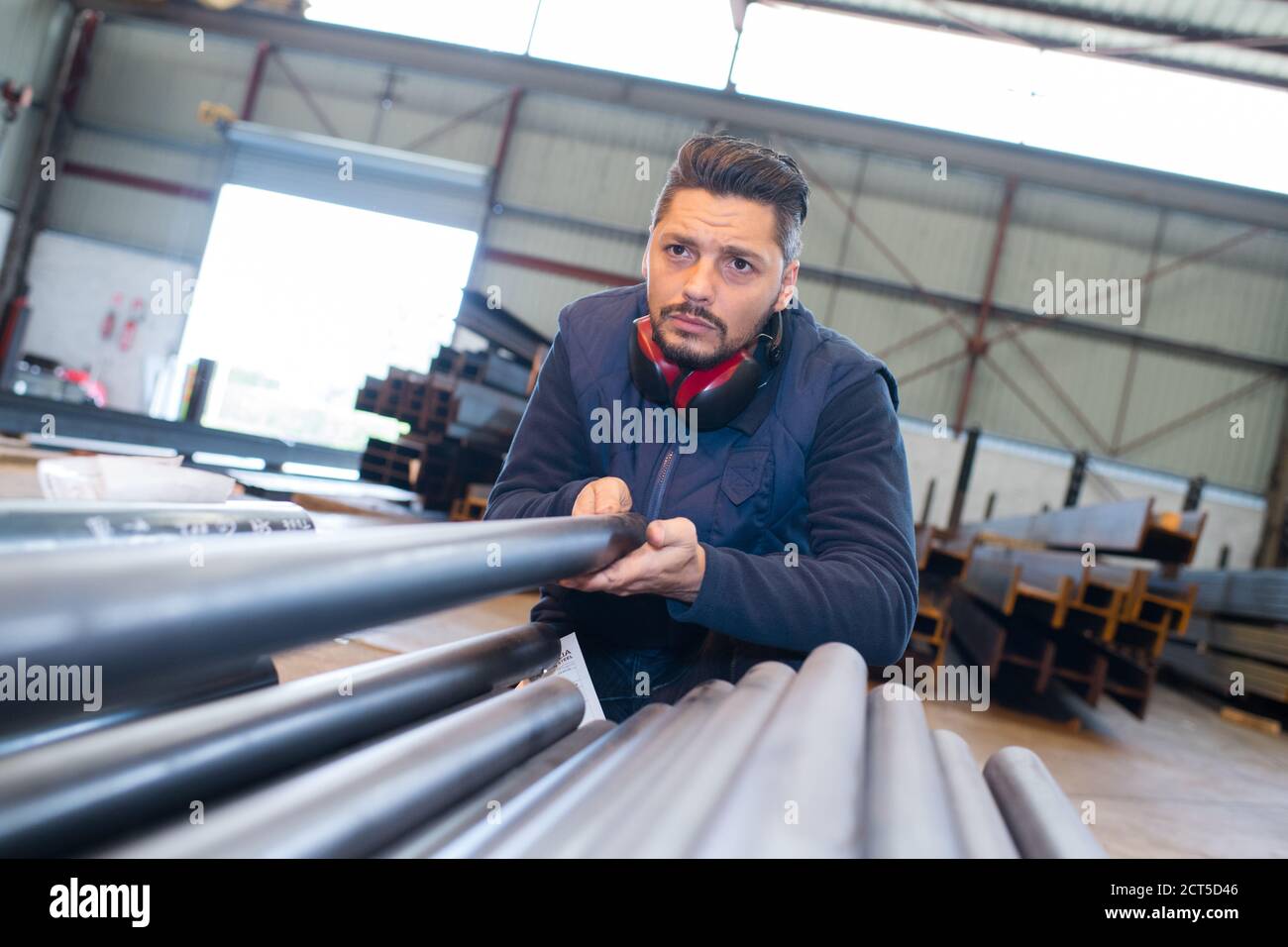 male worker in pipe industry factory warehouse Stock Photo