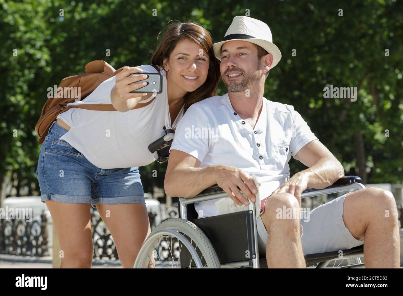 man in wheelchair and his wife taking selfie outdoors Stock Photo - Alamy