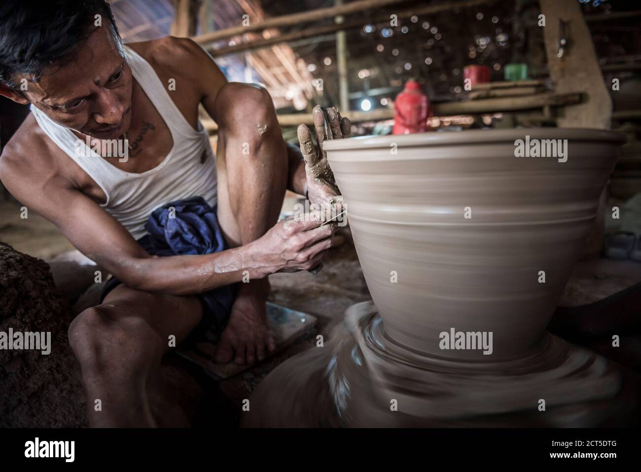 Portrait of a potter in an Oh Bo pottery shed, Twante, near Yangon, Myanmar (Burma) Stock Photo