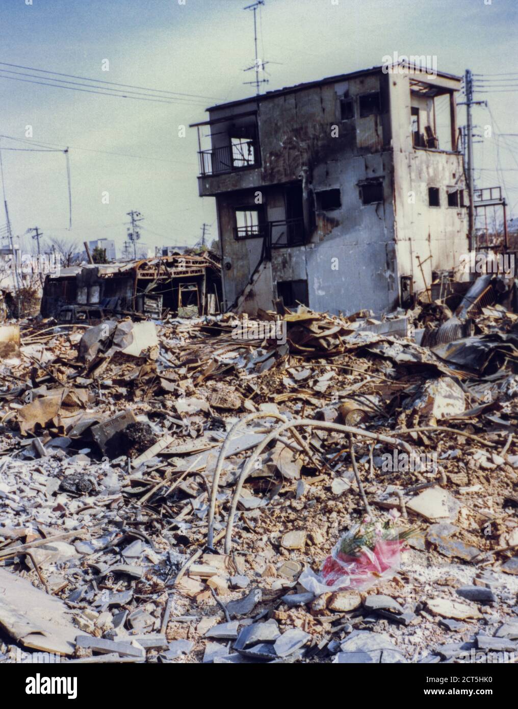 Bouquet of flowers laid in the rubble aftermath of the 1995 Great Hanshin Earthquake in Kobe, Japan Stock Photo