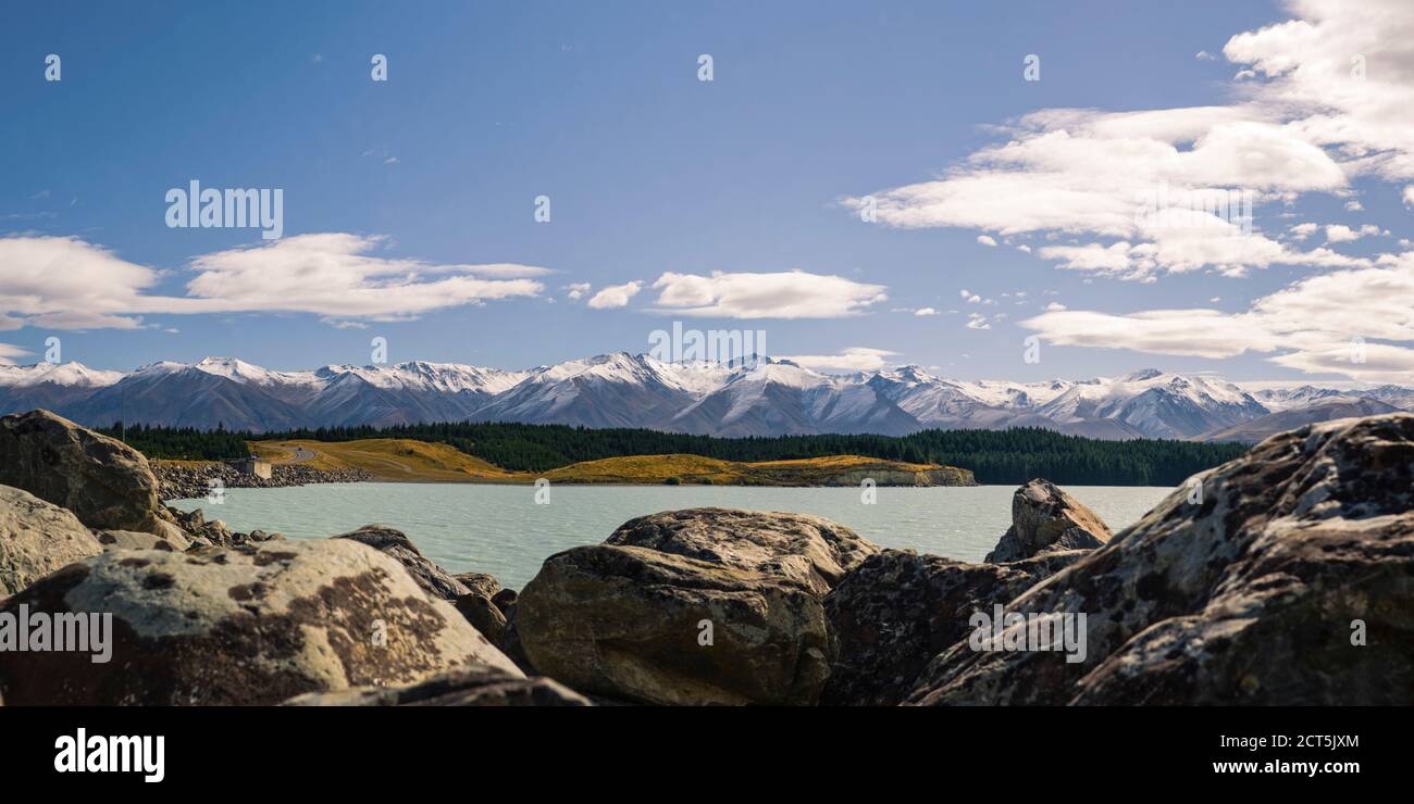 Panoramic Photo of Snow Capped Mountains and Lake Pukaki, South Island, New Zealand Stock Photo