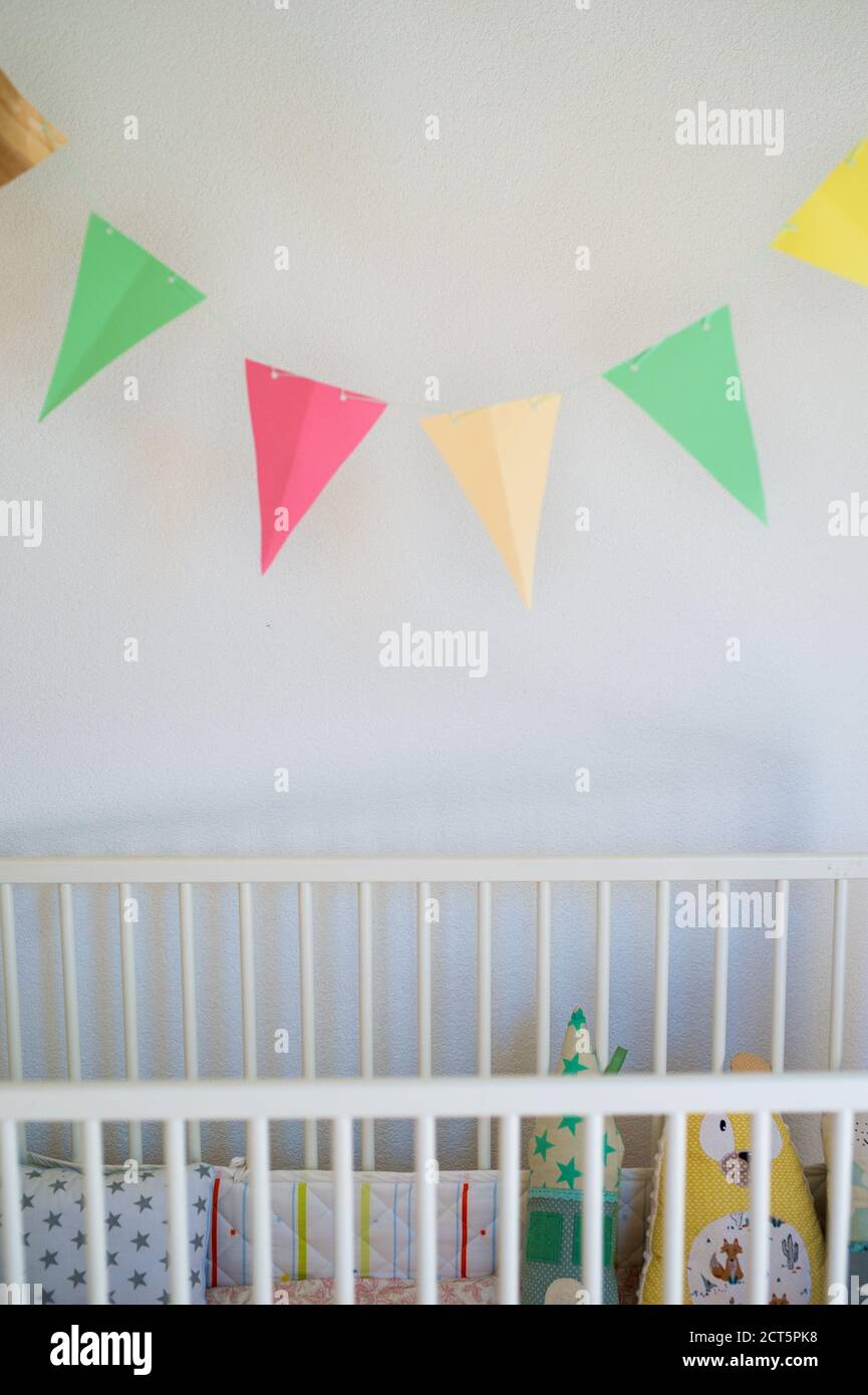Cot in bedroom decorated for newborn baby Stock Photo Alamy