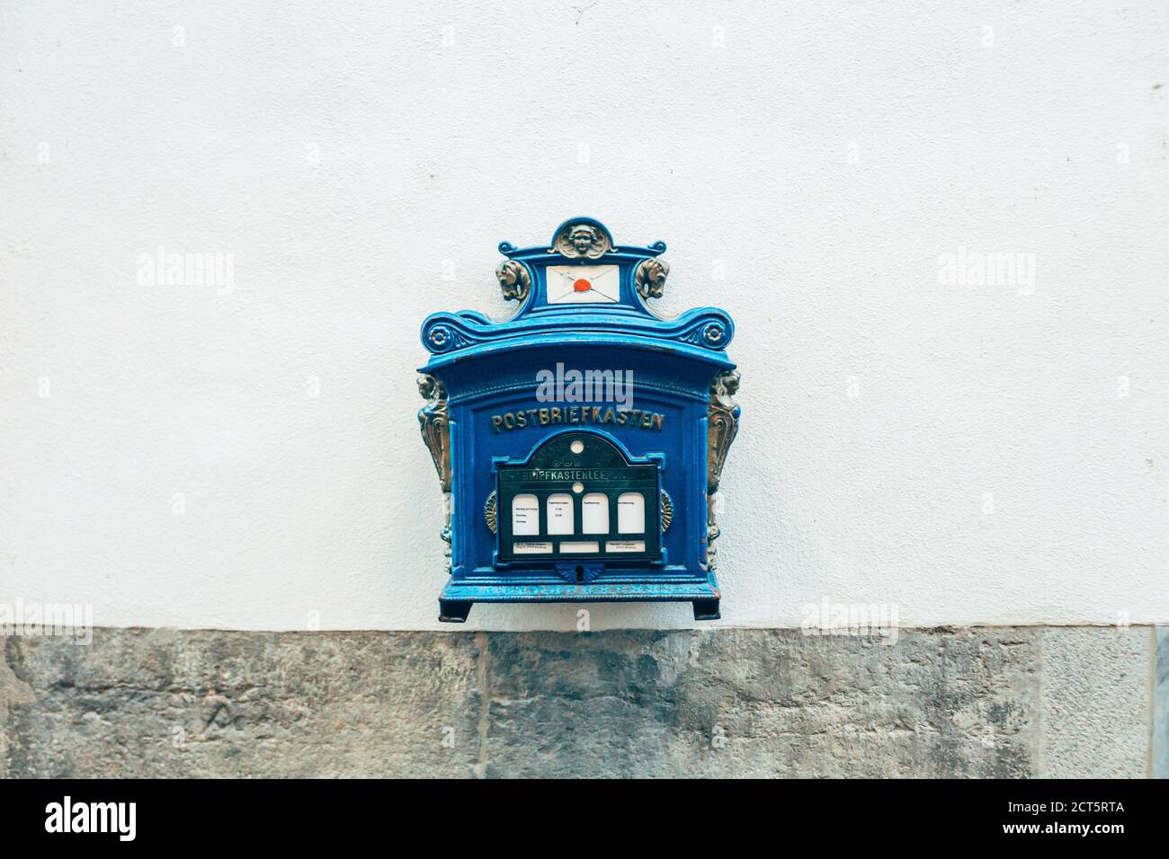 Wurzburg/Germany-3/1/19: a blue Deutsche post mailbox, on the wall of a building. Deutsche Post AG is a German multinational package delivery and supp Stock Photo