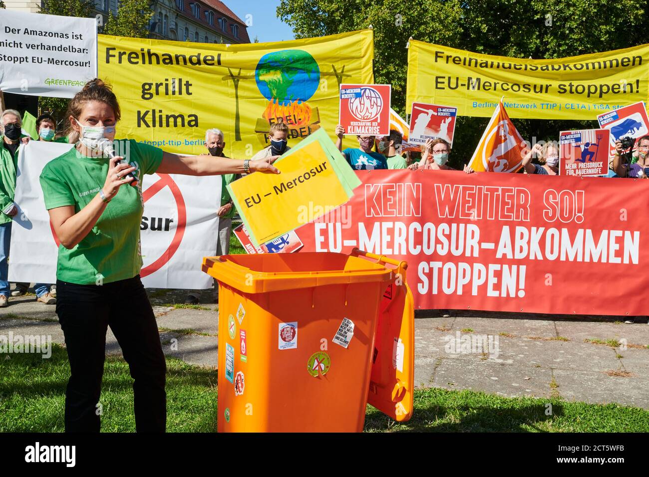 Berlin, Germany. 21st Sep, 2020. Gesche Jürgens, a Greenpeace activist, symbolically throws a poster with the inscription 'EU-Mercosur' into the trash can. Various organisations are protesting in front of the Federal Ministry of Economics under the slogan 'Free trade agreements in the bin!' on the occasion of the informal talks of EU trade ministers against free trade and investment protection agreements between the EU and other states. Credit: Annette Riedl/dpa/Alamy Live News Stock Photo