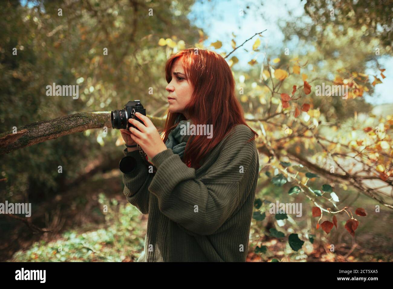 Young woman taking photos in the forest with an old camera Stock Photo ...