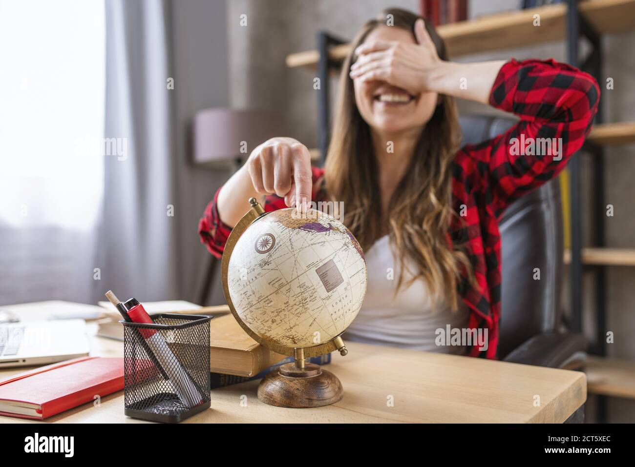 Student is stressed and wants a break with a trip around the world Stock Photo