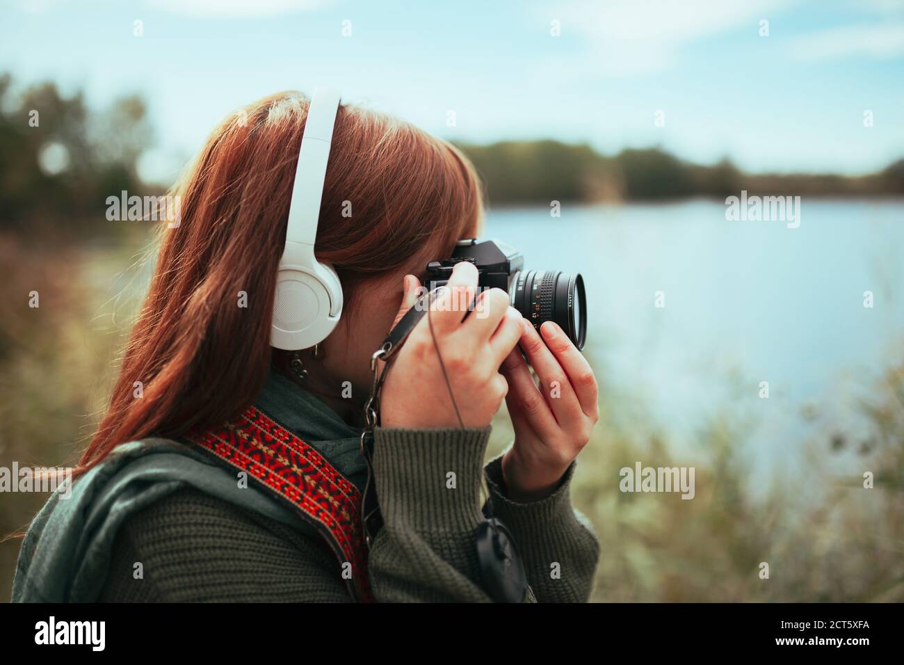 Young woman taking photos in the forest with an old camera Stock Photo ...