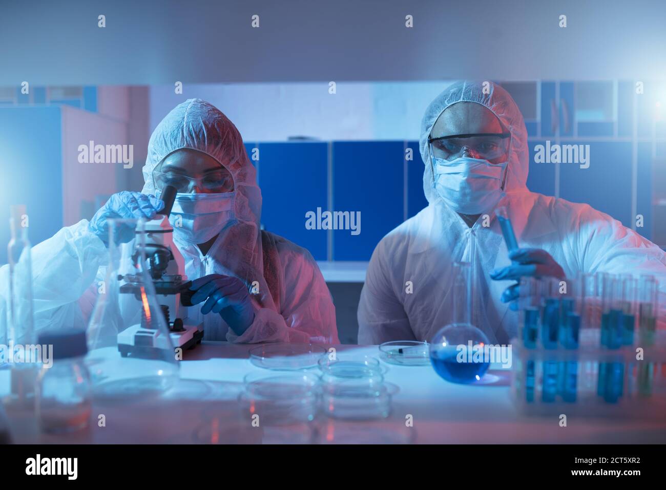 Doctor in the laboratory analyzes samples under a microscope. Pharmaceutical treatment concept. Stock Photo