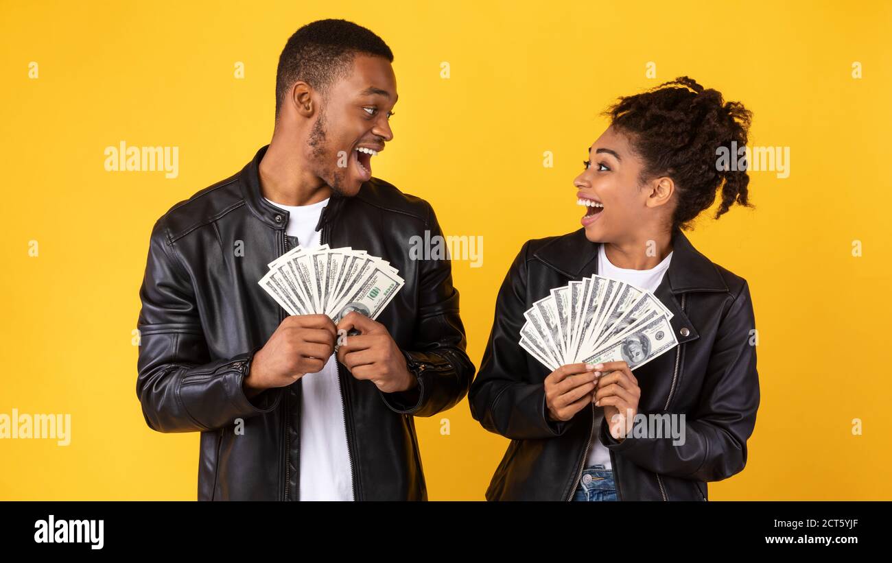 Excited African American Couple Holding Money Posing In Studio Stock ...