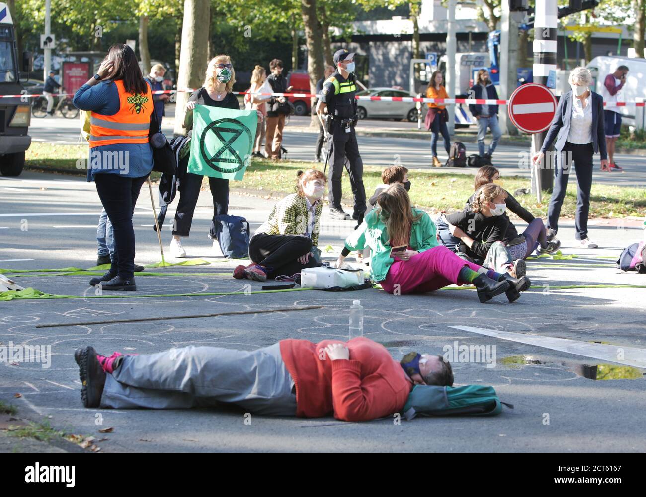 Amsterdam, Netherlands. 21st Sep, 2020. Extinction Rebellion activists block the street during protest at the Zuidas financial district amid the Coronavirus pandemic on September 21, 2020 in Amsterdam, Netherlands. Environmental protectors of Extinction Rebellion make a demonstration against the lobby of the large companies their influence on politics, climate and ecological crisis and this consequences and demand a citizen's assembly for a just climate policy. (Photo by Paulo Amorim/Sipa USA) Credit: Sipa USA/Alamy Live News Stock Photo