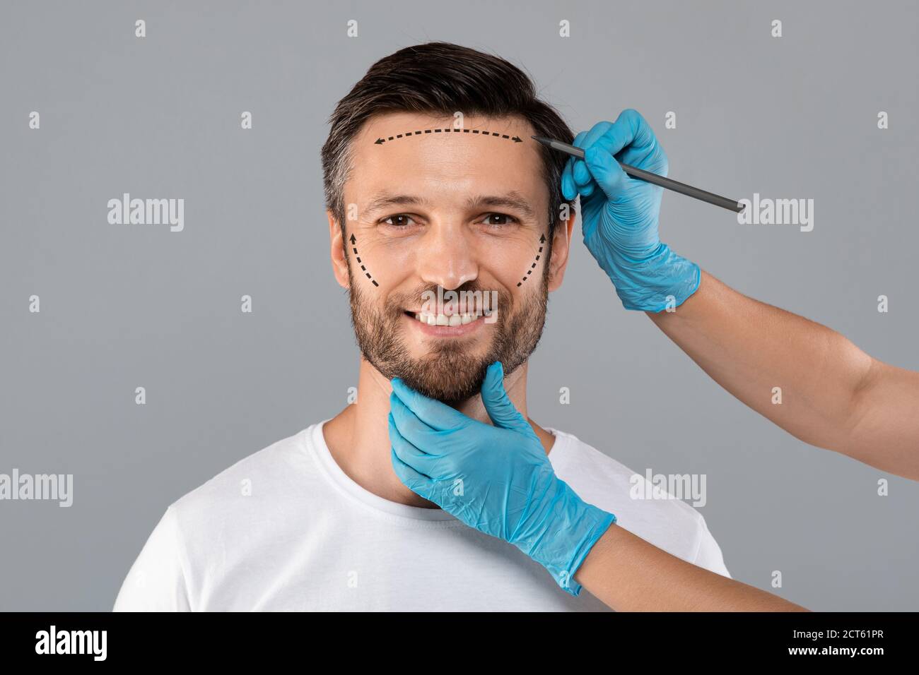 Smiling man getting pencil marks on skin before surgery Stock Photo Alamy