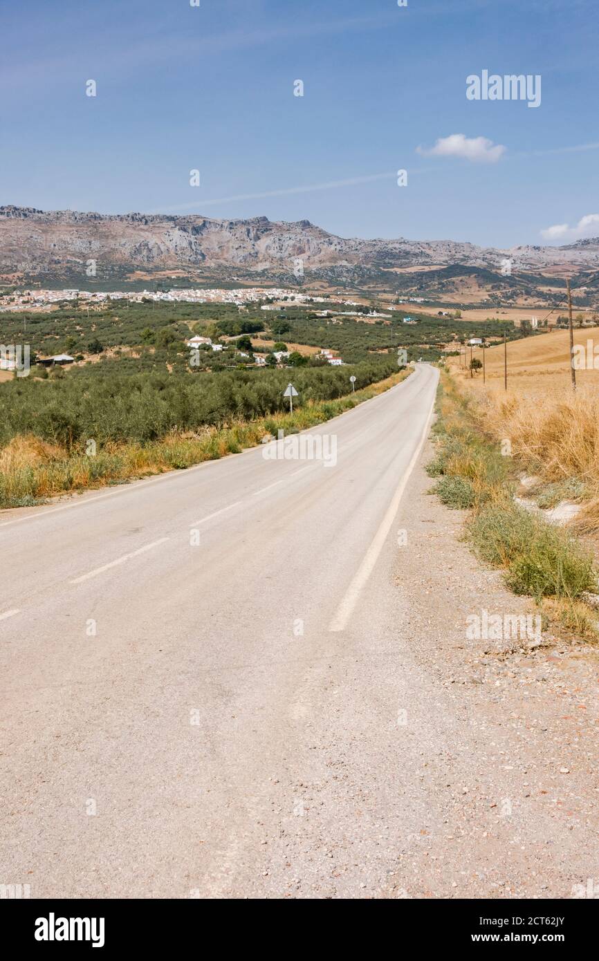 Road with no traffic with Torcal nature reserve behind, Andalucia, Malaga province, Spain Stock Photo
