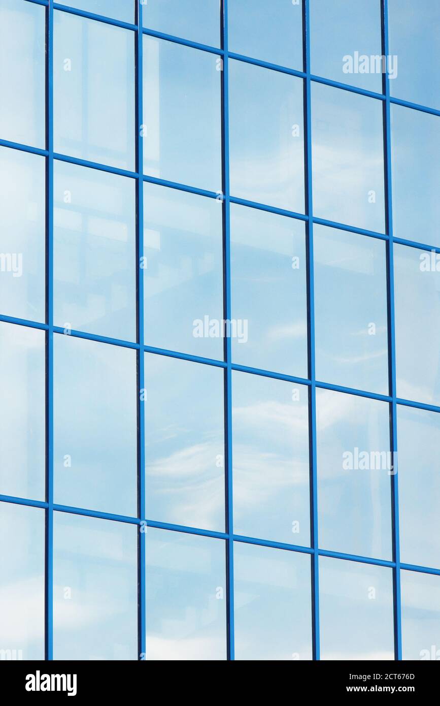 Vertical row of building windows in blue frame with stairs and cloud ...