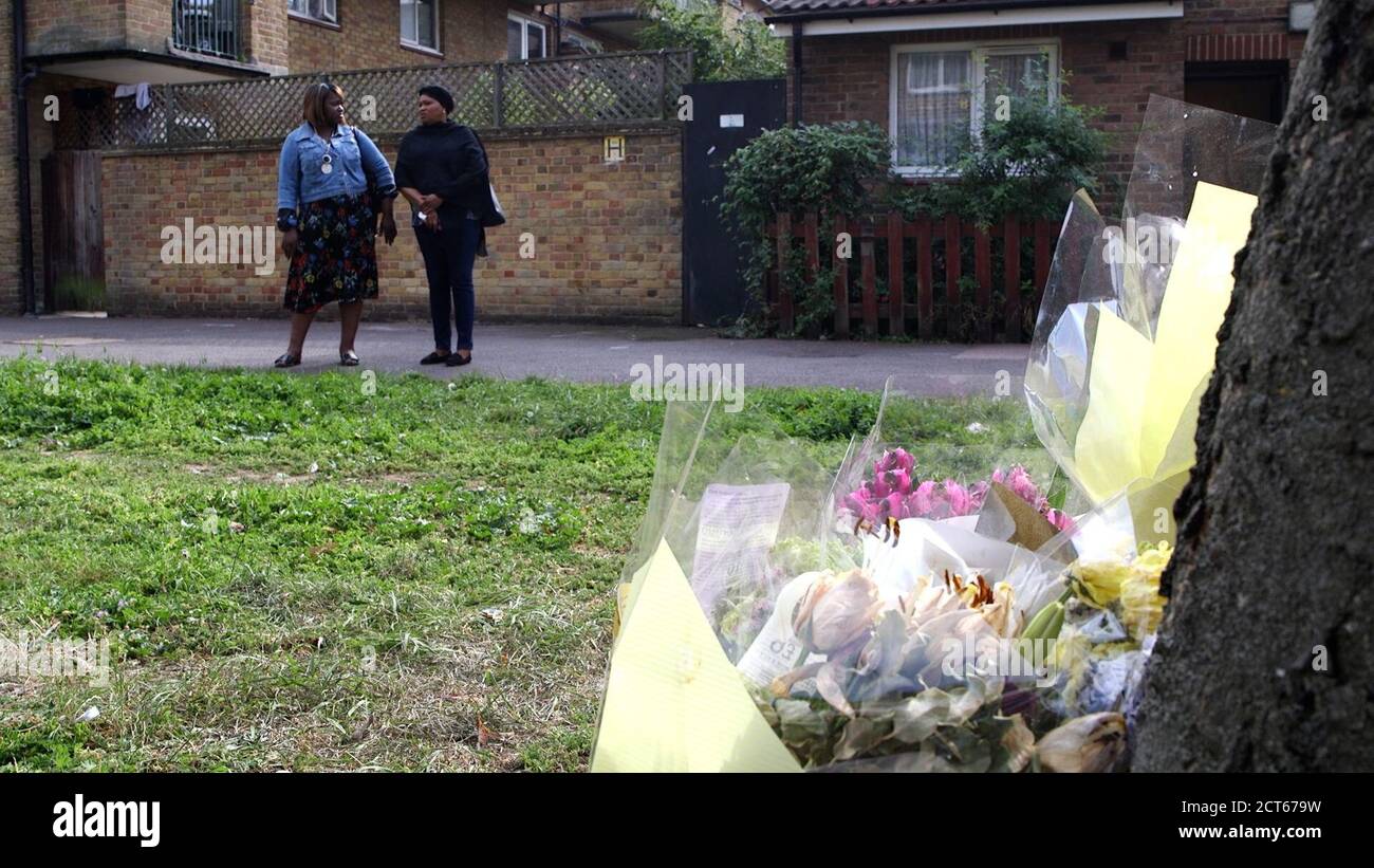 Mariama Baby Kamara (right), the mother of murdered teenager Mohamed Dura-Ray, revisiting the scene of her son's killing in Canterbury Place, Kennington, with a friend, following the five-year anniversary of his death. Stock Photo