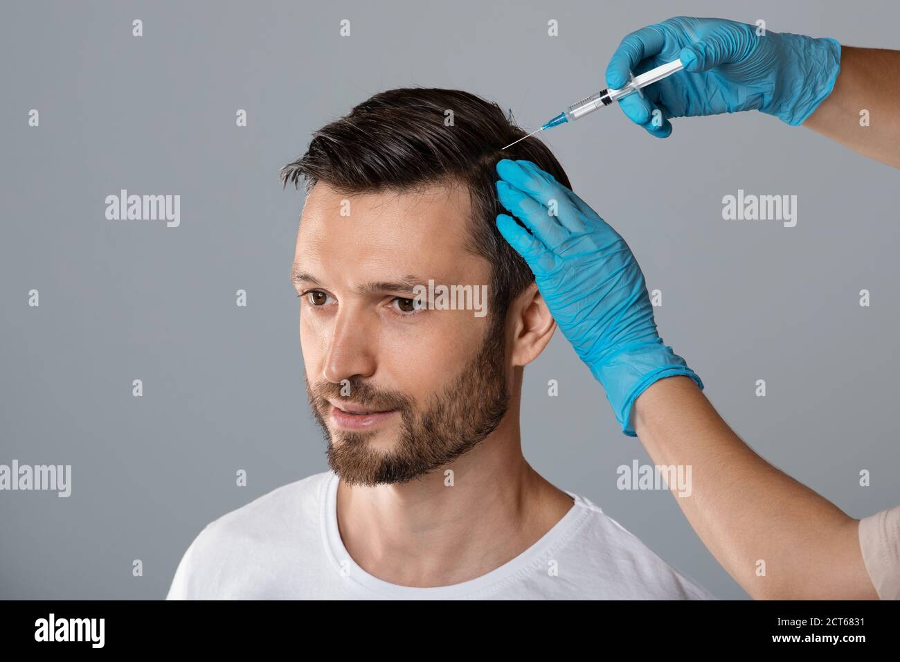 Mesotherapy for hair. Man receiving injections in head Stock Photo