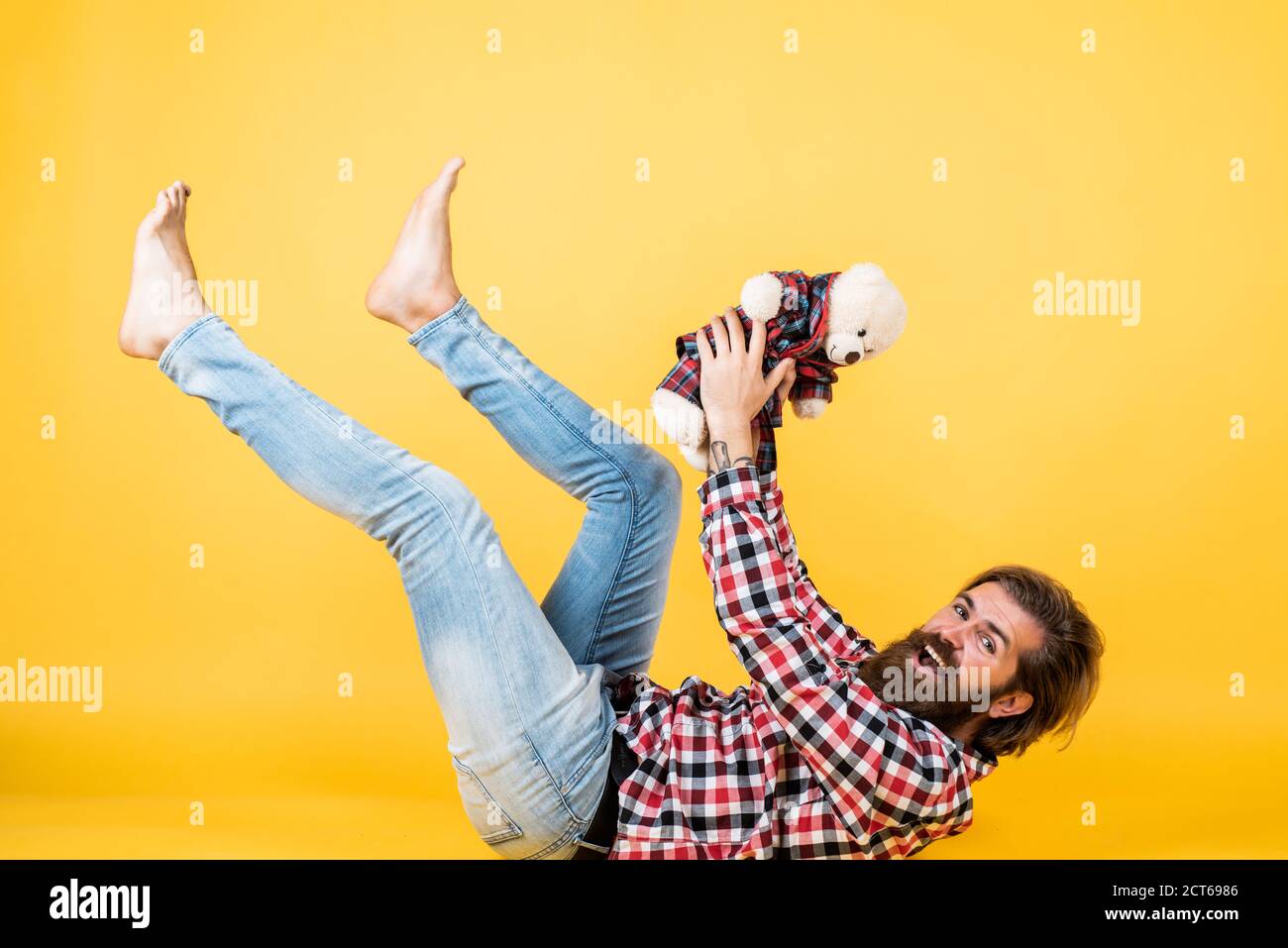 guy enjoy valentines day. best present ever. Valentines day gift for beloved. Holiday celebration concept. Guy with happy face plays with soft toy. Childish mood concept. Stock Photo