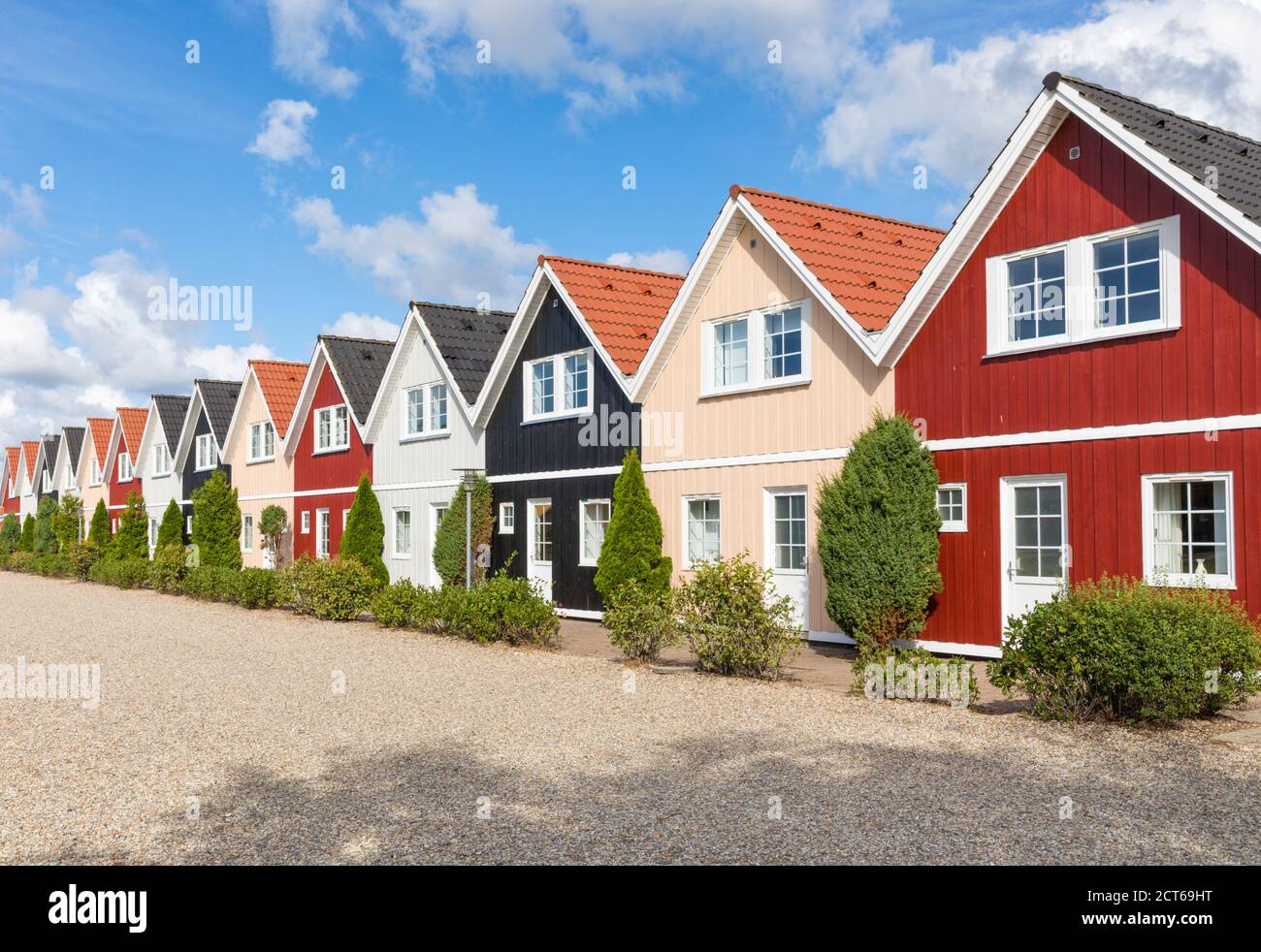 Row of almost identical wooden holiday homes in Denmark Stock Photo