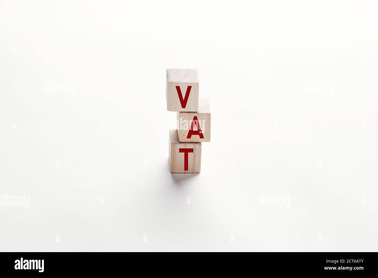 The word VAT value added tax on wooden cubes against white background. Financial management and investment growth in business concept. Stock Photo